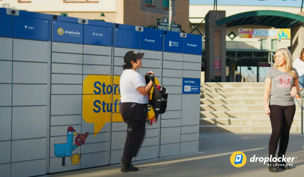 Guest picking up their bag from the Droplocker secure bag storage lockers after an event